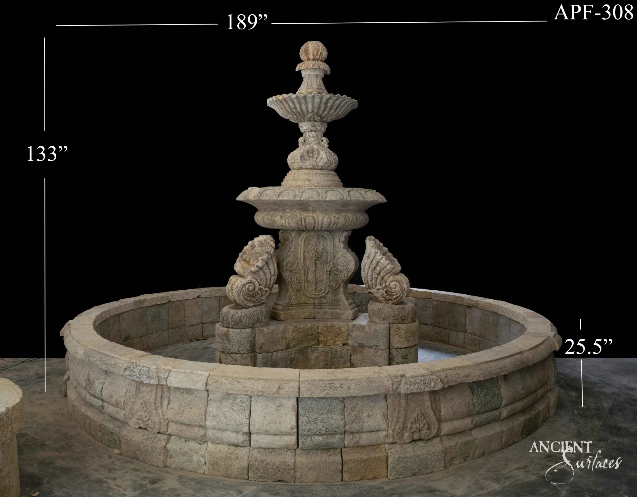 Reclaimed antique limestone pool fountain from Ancient Surfaces with three carved tiers, four large scallop shells around the pedestal and a wide circular basin of coursed blocks with carved rosette panels